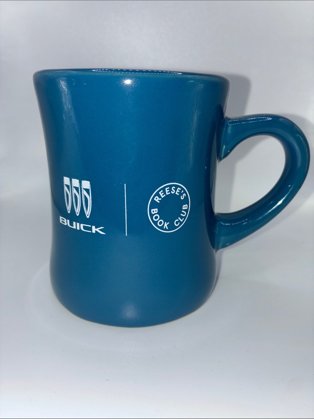 Buick emblem with Reese’s Book Club Promotional Mug